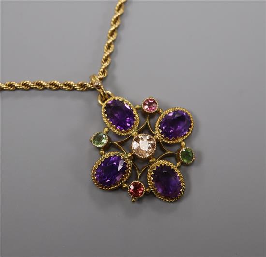 An Edwardian 9ct, amethyst and gem set quatrefoil pendant, on a yellow metal ropetwist chain, pendant 28mm.